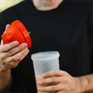 Athlete mixing a post-workout recovery drink